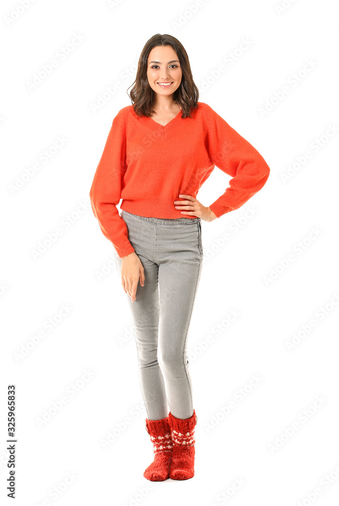 Beautiful young woman in warm sweater on white background