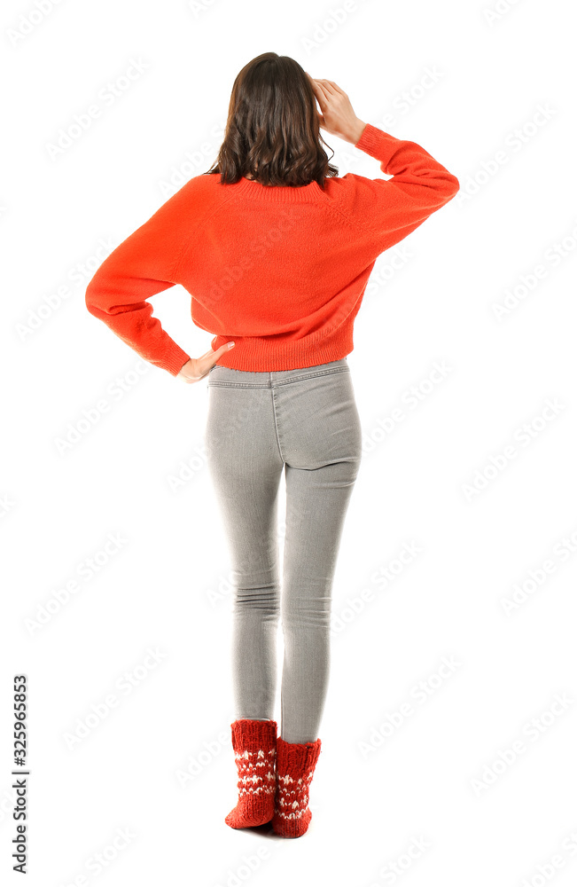 Beautiful young woman in warm sweater on white background, back view