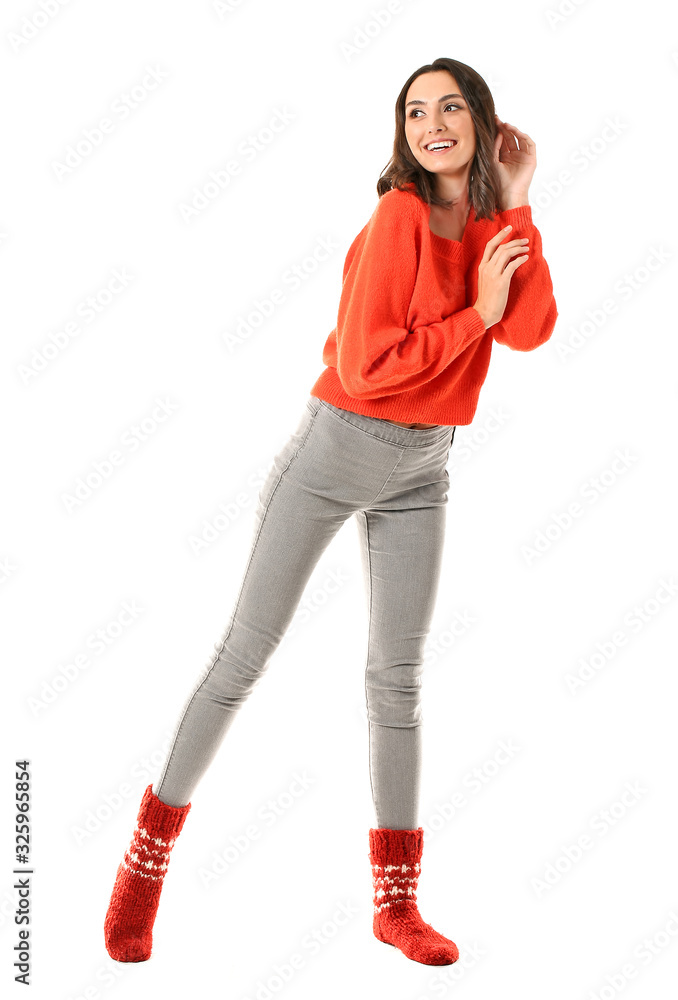 Beautiful young woman in warm sweater on white background