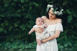 © alexkoral - happy young attractive mom hugs baby boy newborn son in summer