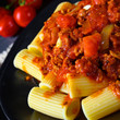 Rigatoni pasta with Bolognese sauce and fresh basil