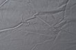 © Lifestyle Graphic - Abstract pattern of a gray crumpled bed sheet in bedroom. Gray wrinkled fabric texture rippled surface, Close up bed sheet in the bedroom.