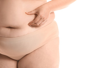 Overweight woman with cellulite problem on white background, closeup