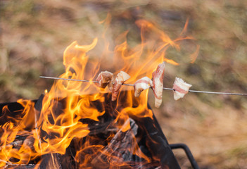 chargrill fire camp cooking meat bacon on skewer wood