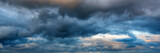Fototapeta  - Dramatic panoramic skyscape with dark stormy clouds