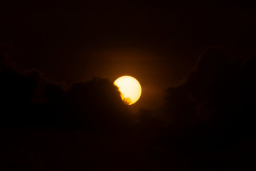 Poster - Big sun on dark sunset sky with dark clouds.