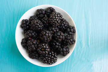 Wall Mural - Berry fruit on blue background.