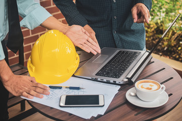 Business people  two people meeting construction project at the computer notebook on desk,Businessman foreman Supervisor hard hat laptop worker