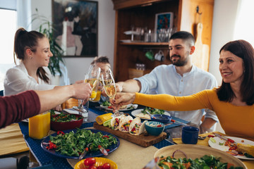 family gathering at home. vegan dinner party