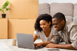Smile african american man and woman looking at laptop