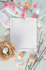 Wall Mural - Happy easter, mockup paper card and easter painted eggs in nest on wooden table. Top view with copy space.