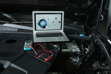 Wall Mural - Laptop with diagram on auto engine. Modern car diagnostic