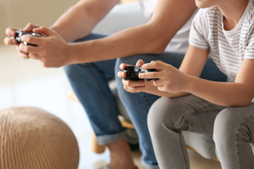 Poster - Father and his little son playing video games at home