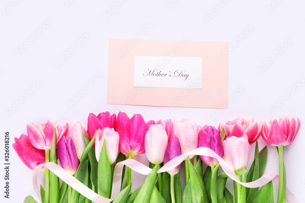 Beautiful flowers for Mother's Day on light background