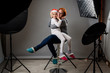 © _jure - Photographing children in professional photo studio with lighting equipment.