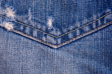 Stitching on jeans. Fragment of denim closeup.