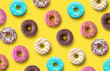 © Soho A studio - Delicious donuts pattern on a yellow background. Top view. Flat lay. Summer concept