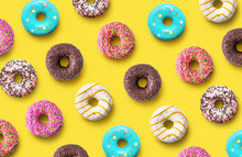 Delicious Donuts Pattern On A Yellow Background. Top View. Flat Lay. Summer Concept