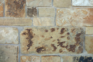 Wall Mural - aged weathered tan brown block cut slate rock wall close-up