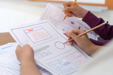 Wall Mural - asian startup designer creating user experience ux web on smartphone or mobile layout development. u
