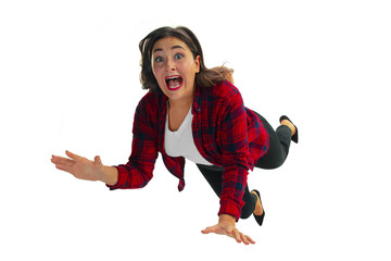 Poster - A second before falling. Caucasian young girl falling down in moment with bright emotions and facial expression. Female model in casual clothes. Shocked, scared, screaming. Copyspace for ad.