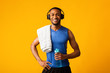 Healthy black sports guy holding bottle of water