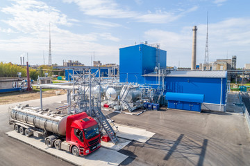 pouring chemical components into a tanker at the factory