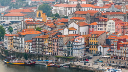 Wall Mural - Beautiful view of the Douro River timelapse and the embankment of the historic centre of Porto city on the blue sky background in Portugal at summer time.