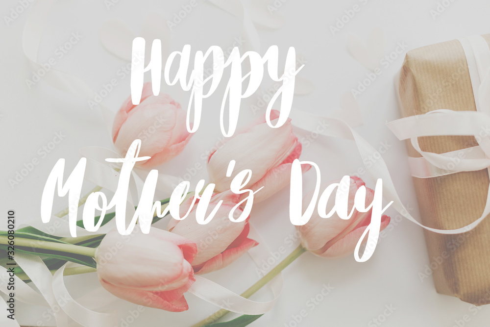 Happy mother's day.  Happy mother's day text and pink tulips with gift box on white background. Stylish soft image. Floral Greeting card. Happy Mothers day. Handwritten lettering - obrazy, fototapety, plakaty 