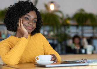 Wall Mural - Pensive black woman having coffee break at cafe