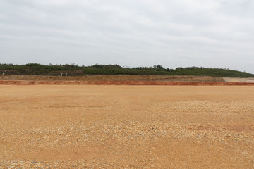 Perspective view of open and level dirt ground