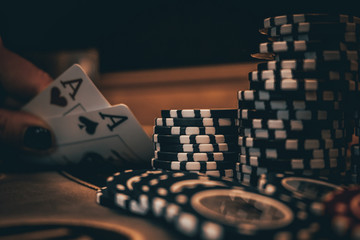 Dealer or croupier shuffles poker cards in a casino on the background of a table, chips. Concept of poker game, game business. Playing for money, a big win, a jackpot, gambling, a desire to get rich.