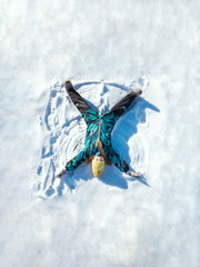 Happy girl lying on snow and making snow angel figure. Freedom, climat change and beautiful winter concept. Stock video.