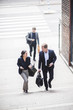 © Maskot - Male and female entrepreneurs climbing staircase in city
