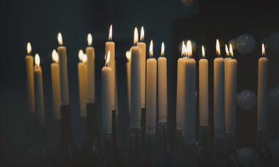 burning candles on a dark background. The concept of mourning.