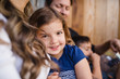 © Maskot - Portrait of smiling girl sitting with family