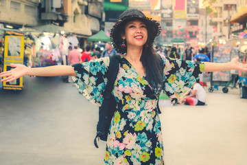 Happy young asian woman spending her vacation in  Khao San road, Khao San road is tourist hub of Bangkok.