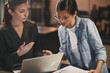 © Flamingo Images - Diverse businesswomen talking together over a laptop in an offic
