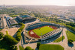 © Maskot - Aerial view of stadium in malmo city against sky on sunny day