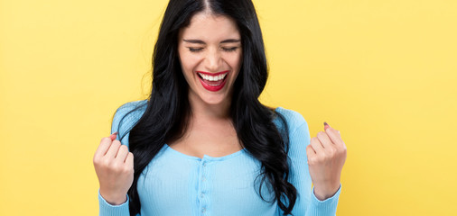 successful young woman on a yellow background