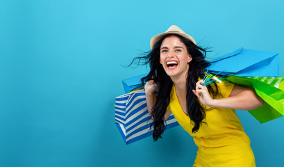 Wall Mural - Woman with many shopping bags on a blue background