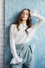 Fashionable Woman Wearing Trendy Vintage Style White Blouse, Light Blue High Waist Trousers. Spring, Summer Fashion Concept