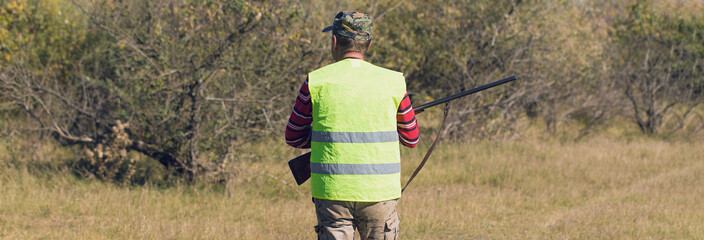 Hunters with a german drathaar and spaniel, pigeon hunting with dogs in reflective vests.