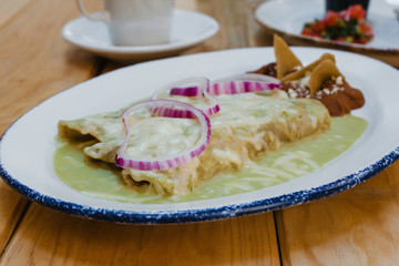 Wall Mural - enchiladas verdes Mexican Food with onions and cheese in Mexico