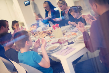 Wall Mural - Eid Mubarak  Islamic family praying before halal Iftar dinner