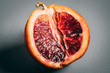 © Inti St. Clair - Cut blood orange on grey background