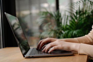 Closeup of copywriters hands typing on laptop computer, editing article for website, working project, sitting at workplace. Programmer writing code. Student studying, online education concept 