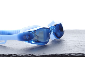 Professional Blue glasses for swimming on a gray background