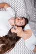 © Maksymiv Iurii - Happy sensual young couple lying in bed together
