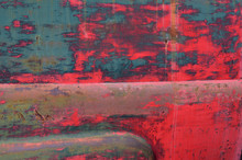 Abstract Blue And Red Flaking Paint On The Side Of An Old Abandoned Rusting Truck